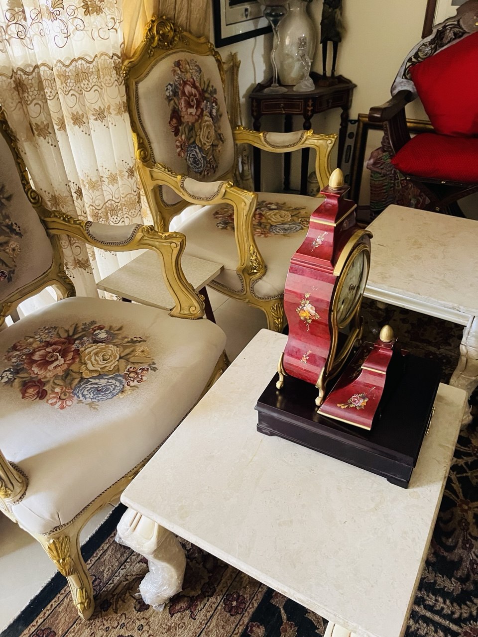 Heritage hall interior with carved mirror and red-cushioned chairs in Accra by by FreeCoat